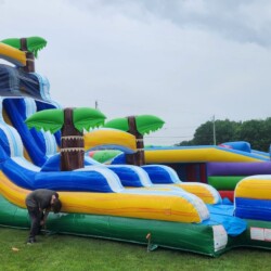 Someone setting up a giant inflatable slide.