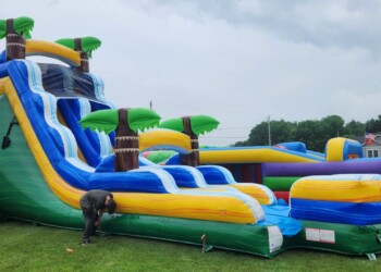 Someone setting up a giant inflatable slide.